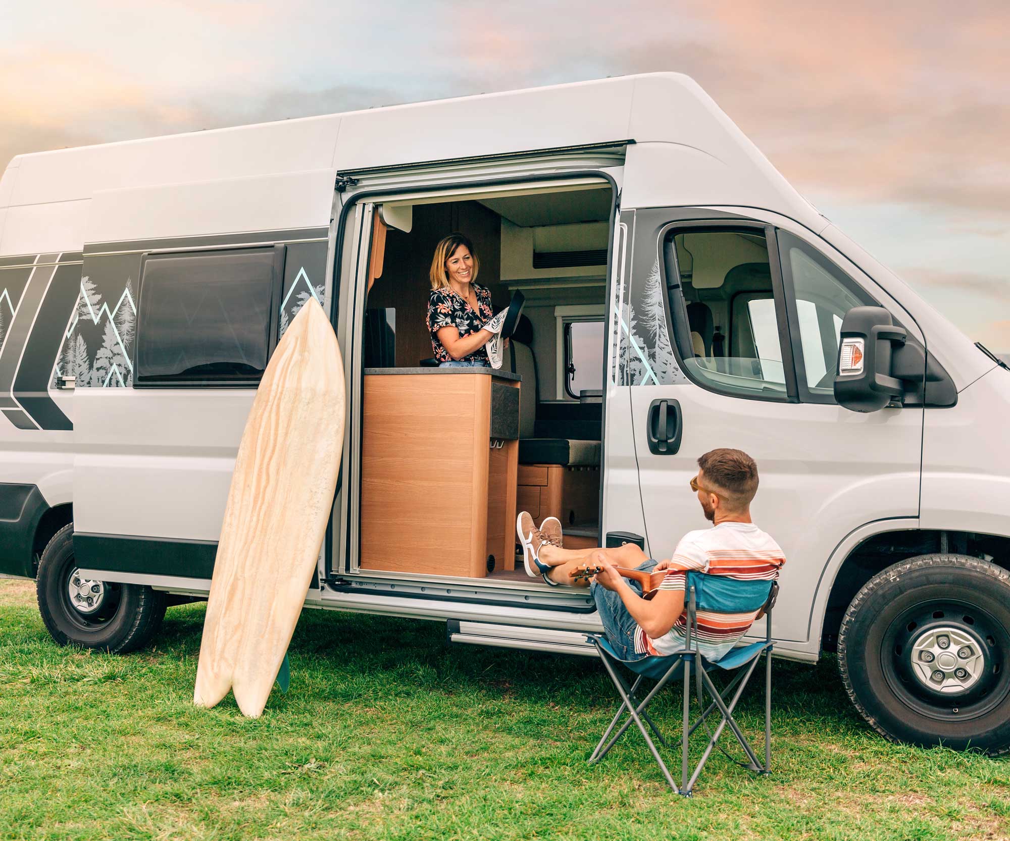 campervan with woman in doorway and man on chair looking in